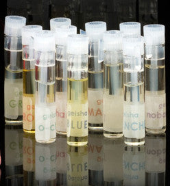 fourteen small bottles of geisha perfume samples